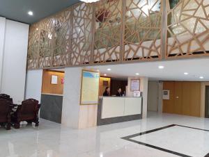 a lobby with a reception desk in a building at Khách sạn Hữu Nghị in Vinh