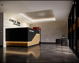 a lobby with a check in counter in a building at Check Inn Permata Hijau in Semarang