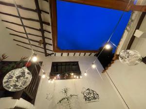 a large blue screen in a room with lights at Casa Real Barichara in Barichara +28 photos