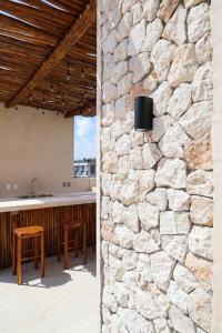 a stone wall in the kitchen of a house at Akbal Tulum in Tulum