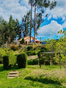 a house sitting on top of a grassy hill at CASA DE PIEDRA EL ZAPATO in Suesca