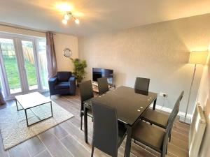 a living room with a dining room table and chairs at Genesis 3 bedroom Home Telford- sleeps up to 5 in Oakengates