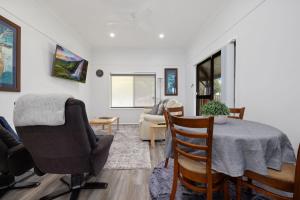 a living room with a table and chairs at Snow-Berri in Berridale