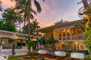 a man walking in front of a building at Green Gallery Beach Boutique Hotel in Hua Hin