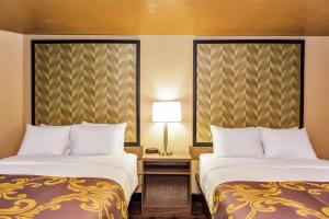 Postel nebo postele na pokoji v ubytování Aarya Hotel By Niagara Fashion Outlets