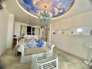 a living room with a chandelier and a bed at Green Gallery Beach Boutique Hotel in Hua Hin +95 photos