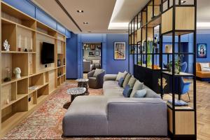 a living room with blue walls and a couch at Residence Inn by Marriott Munich Central in Munich