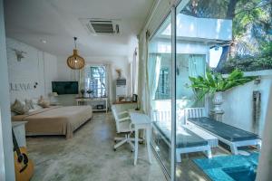 a bedroom with a bed and a desk in a room at Green Gallery Beach Boutique Hotel in Hua Hin
