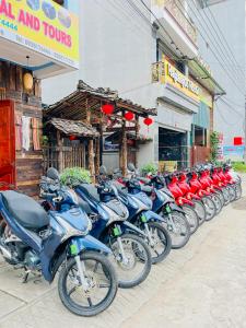 a row of motorcycles parked in front of a store at HagiangGo Hostel-Motorbikes rental and Tour in Ha Giang