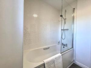 a bathroom with a shower and a bath tub at Genesis 3 bedroom Home Telford- sleeps up to 5 in Oakengates