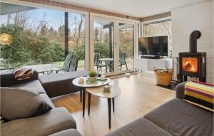 a living room with two couches and a fireplace at 3 Bedroom Awesome Home In Silkeborg in Silkeborg