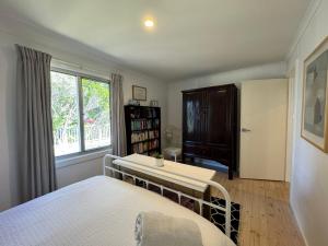 a bedroom with two beds and a window at No 34 Where Nature Meets the Ocean Pet Friendly in Robe