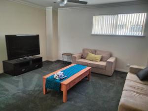 a living room with a couch and a coffee table at Harrison's Retreat - Rockingham in Rockingham