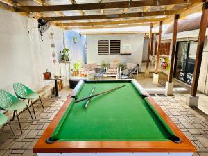 a pool table in the middle of a living room at Seven Star Lodge in Port Vila