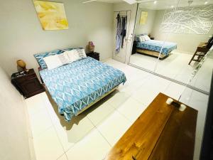 a bedroom with a bed and a mirror in it at Seven Star Lodge in Port Vila