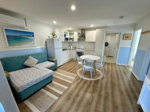 a living room with a couch and a table at Driftwood - Bunbury in Bunbury +11 photos