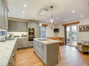an open kitchen and dining room with a large island at Babbling Brook Barn in Abbots Bromley