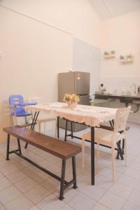 a dining room with a table and chairs in a kitchen at The Karaoke Homes Ipoh, Oldtown in Ipoh