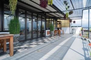 a patio with benches and potted plants on a building at Urbanview Hotel Omah Anin Batu by RedDoorz in Tlekung