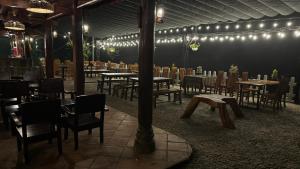 a dining room with tables and chairs and lights at Ly House in Sa Pa