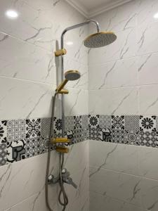 a bathroom with a shower with black and white tiles at ELFA APPARTEMENTS Familiaux in Agadir +58 photos