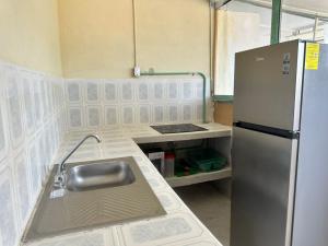 a kitchen with a sink and a refrigerator at Casa Mediterraneo in Chamela