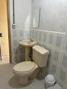 a bathroom with a toilet and a sink at Casa Mediterraneo in Chamela