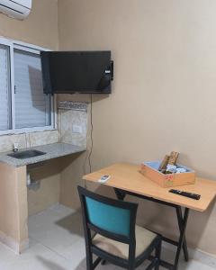 A television and/or entertainment centre at HOSPEDAJE LA NORMA