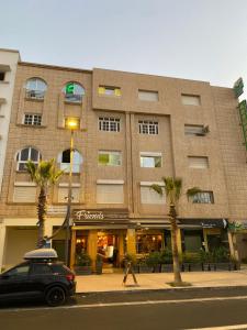 a black car parked in front of a building at ELFA APPARTEMENTS Familiaux in Agadir