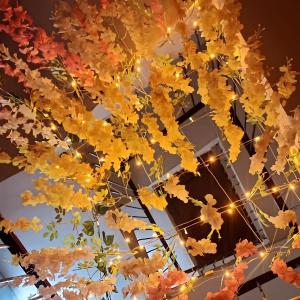 a bunch of yellow leaves hanging from a ceiling with lights at The kashi palace inn ,Varanasi ! fully-Air-Conditioned hotel at prime location with Parking availability, near Kashi Vishwanath Temple, and Ganga ghat in Varanasi