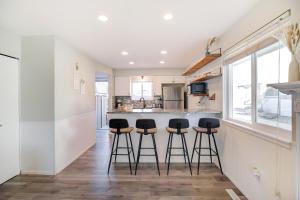 a kitchen with a counter and bar stools at Comfy Family-size Townhome 2BR-5 People near Old town Arvada-10min walk in Arvada