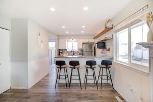 cocina con barra y taburetes en Comfy Family-size Townhome 2BR-5 People near Old town Arvada-10min walk, en Arvada