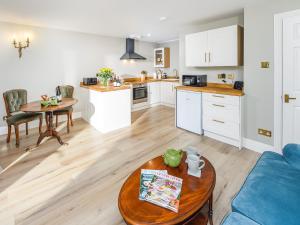 a kitchen and living room with a couch and a table at Angel Lane in Alnwick