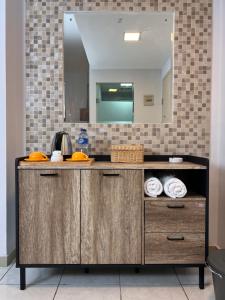 a bathroom with a vanity with a mirror at Fastrooms Bekasi in Bekasi