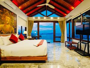 a bedroom with a large bed and a television at Sandalwood Luxury Villa Resort in Lamai