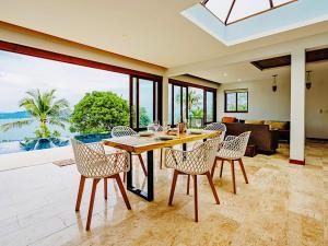 a dining room with a table and chairs in a house at Sandalwood Luxury Villa Resort in Lamai