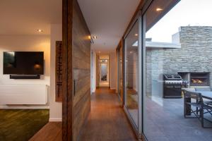 a hallway of a house with a living room and a fireplace at Amaroo in Queenstown