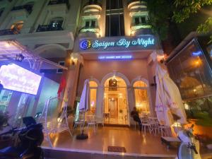 a building with a sign that reads supreme city night at Saigon By Night Boutique Hotel in Ho Chi Minh City