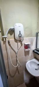 a bathroom with a hair dryer and a sink at Destiny Riverside Hotel in Kota Bharu