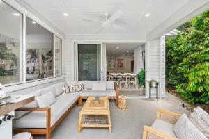 a living room with a couch and a table at Hamptons by Khove in Gold Coast