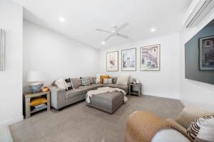 a living room with a couch and a chair at Hamptons by Khove in Gold Coast