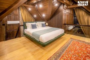 a bedroom with a bed with wooden walls and a rug at StayVista at Frozen Fall in Gulmarg