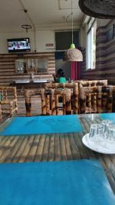 una persona sentada en una mesa en un restaurante en Risong Family Guest Gouse Majuli, en Majuli
