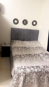 a bedroom with a bed with a gray comforter at Al badaa in Dubai