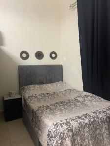 a bedroom with a bed with a gray head board at Al badaa in Dubai