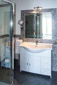 a bathroom with a sink and a mirror and a shower at Maniel Beach Hotel in Letojanni
