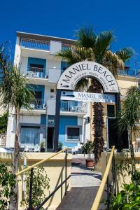 a building with a sign that readsamedel beach marriott resort at Maniel Beach Hotel in Letojanni