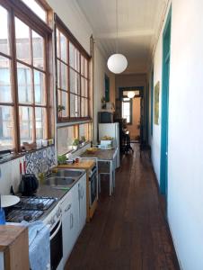 a kitchen with a sink and a stove at República Hostel in Valparaíso