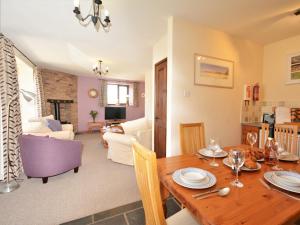 een eetkamer en een woonkamer met een houten tafel bij 2 Bed in Totnes 61775 in Ipplepen