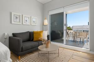a living room with a couch and a table at 220 On Loop Luxury Apartments in Cape Town